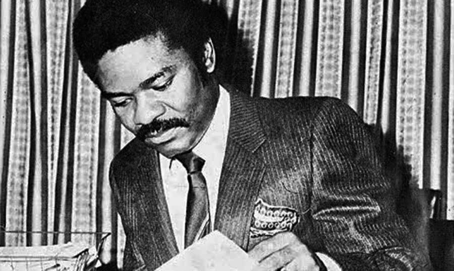 Dele Giwa reading a book